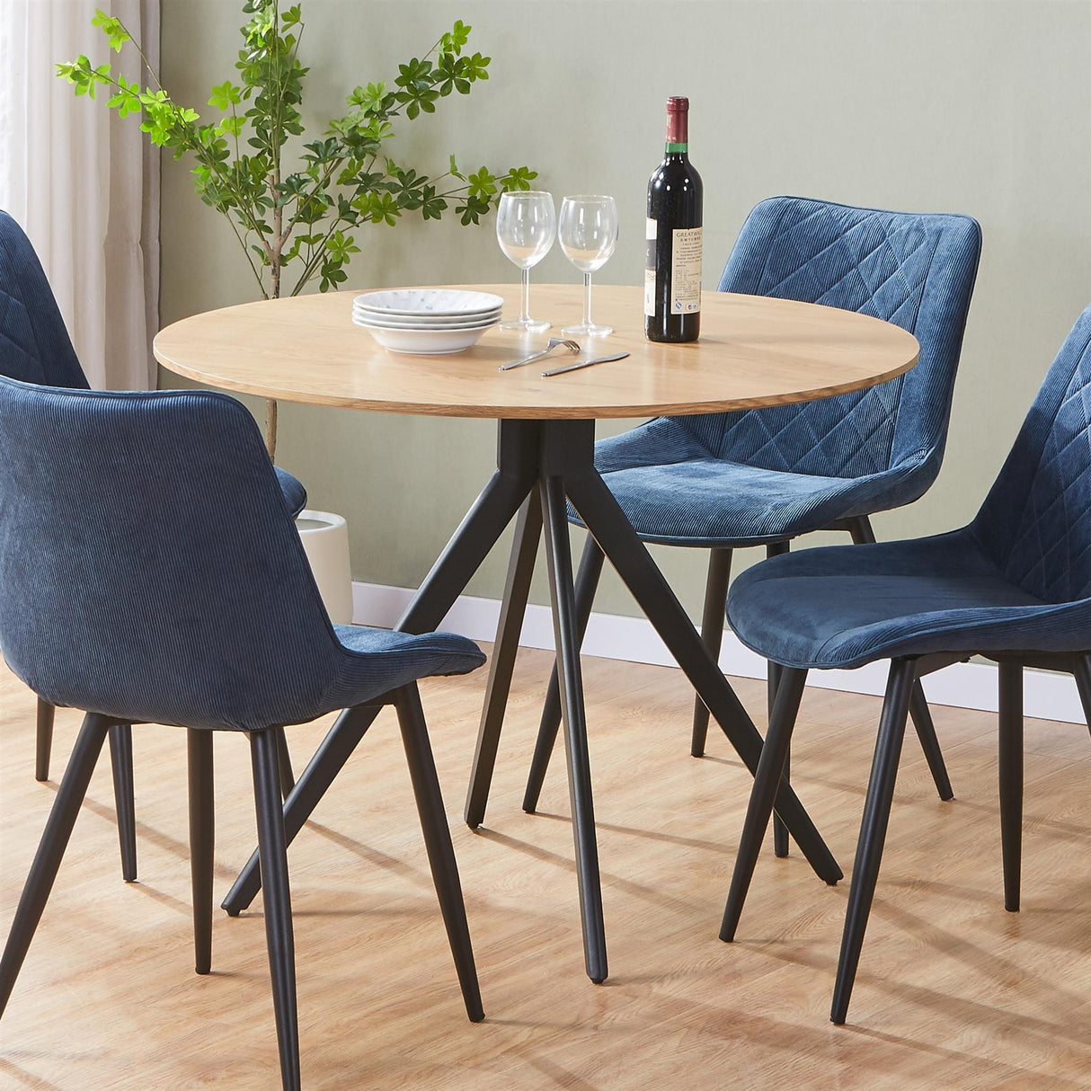 Aspen round dining table, light oak effect top with black pedestal leg