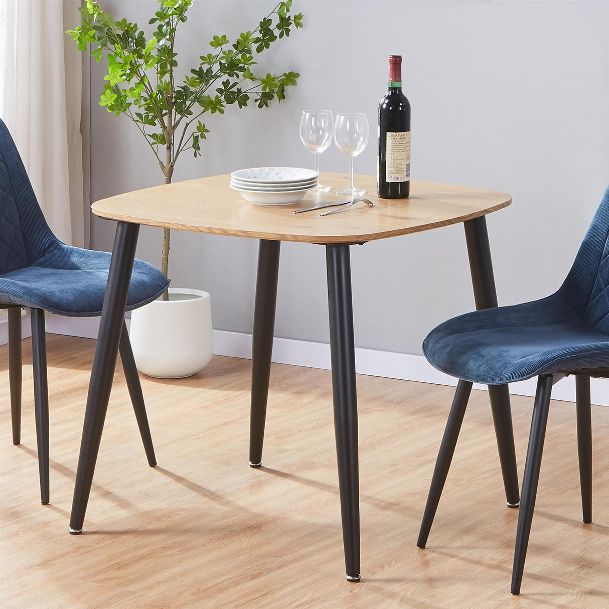 Aspen square dining table, light oak effect top with black tapered legs